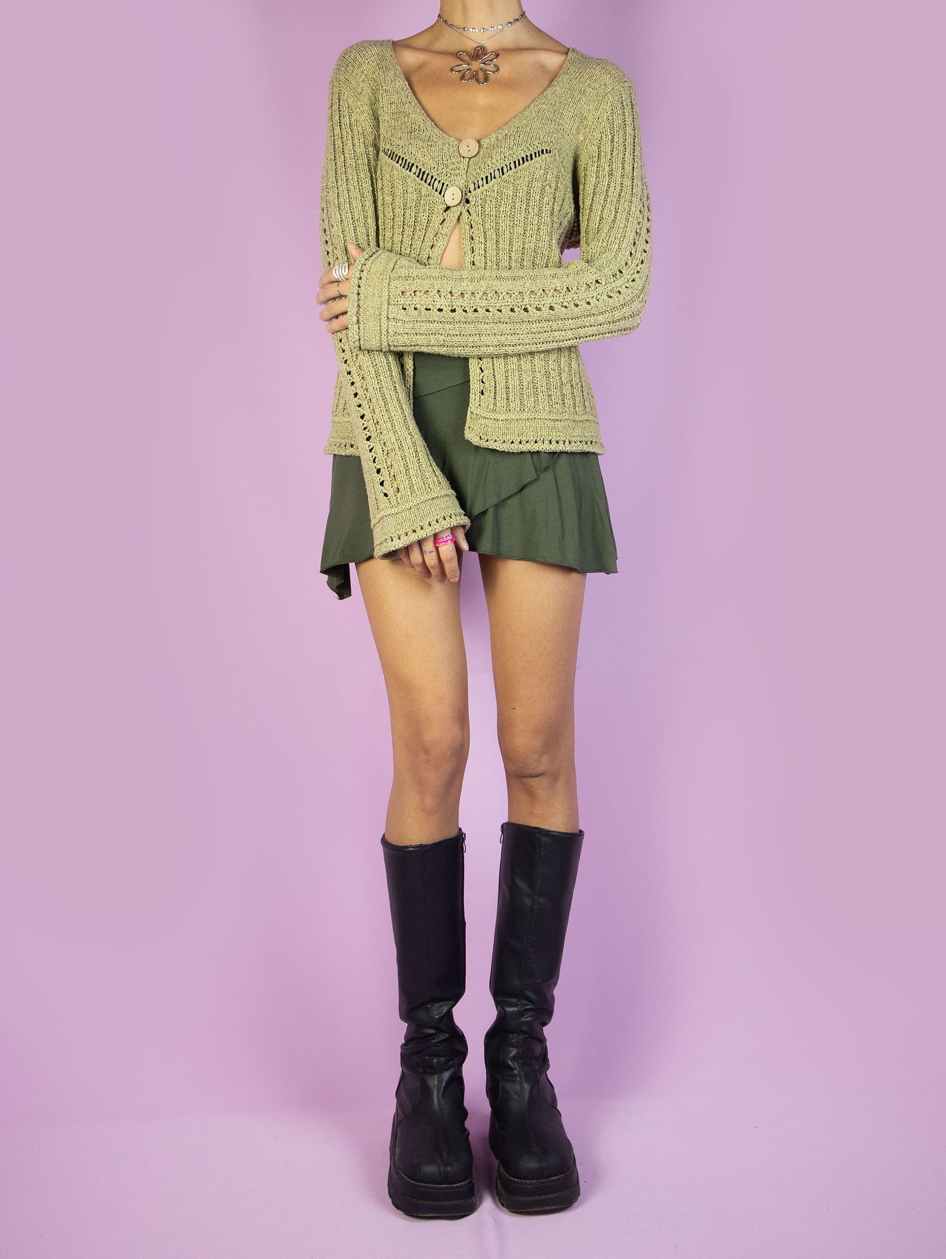 The Y2K Green Two-Button Cardigan is a vintage ribbed cardigan in green-beige with bell sleeves and a two-button closure, featuring a v-neck. Super cute boho fairy grunge 2000s knit sweater.