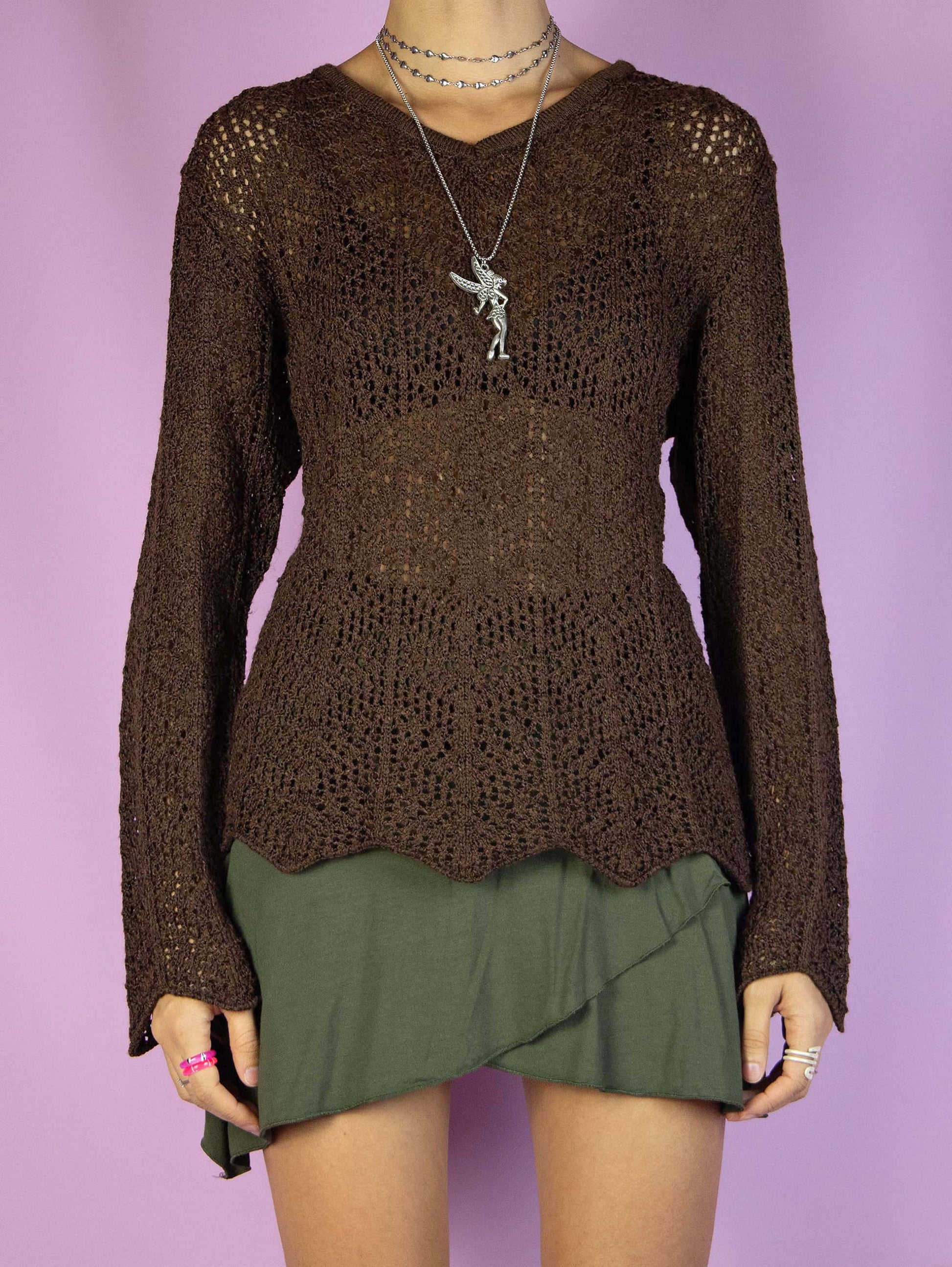 The Y2K Dark Brown Crochet Top is a vintage long-sleeve dark brown crochet knit top with a v-neck. Super cute boho fairy grunge 2000s sweater.