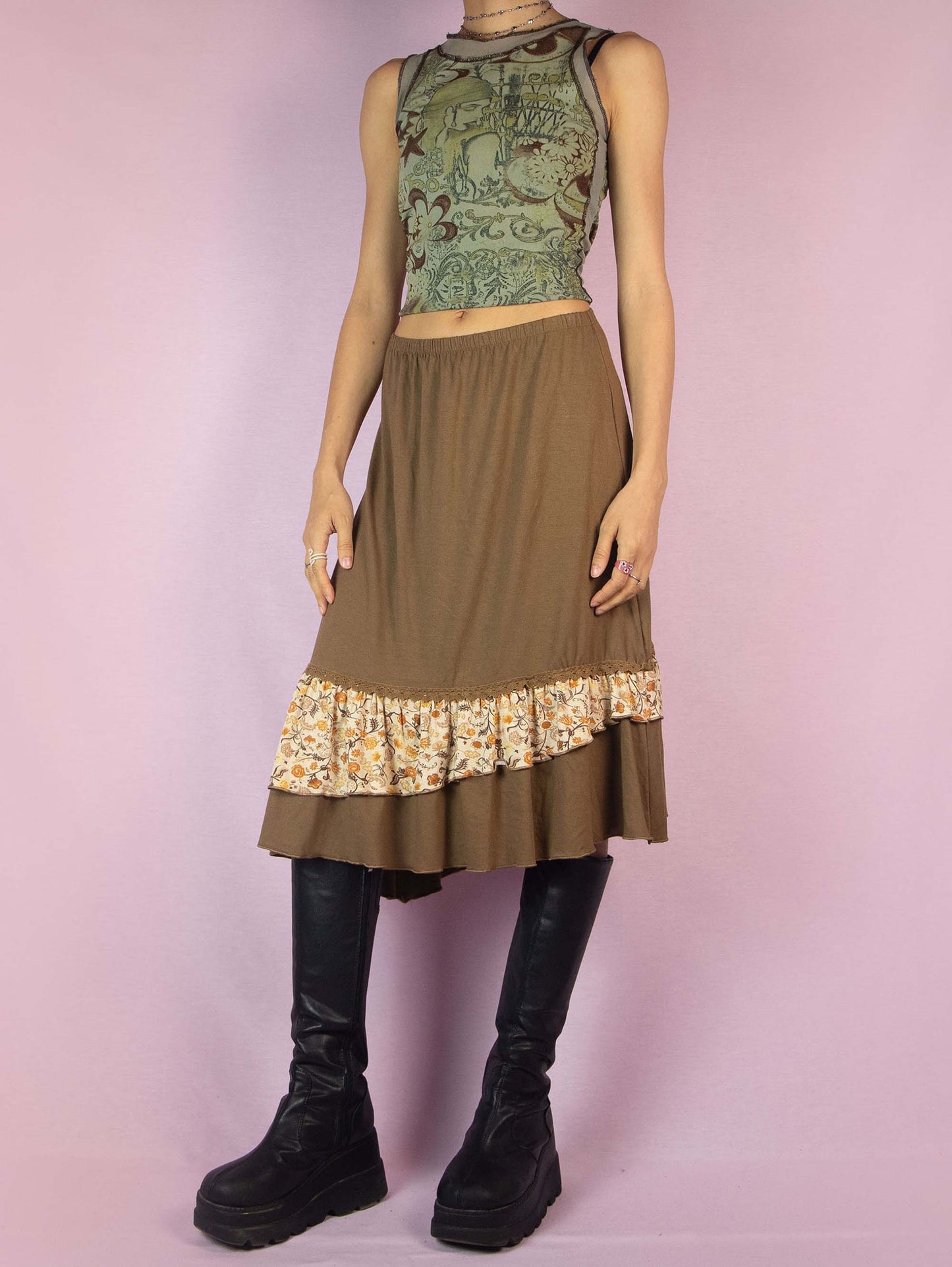 The Y2K Asymmetric Brown Midi Skirt is a vintage 2000s fairy grunge cottagecore style skirt with an asymmetric floral print ruffle hem and elastic waist.