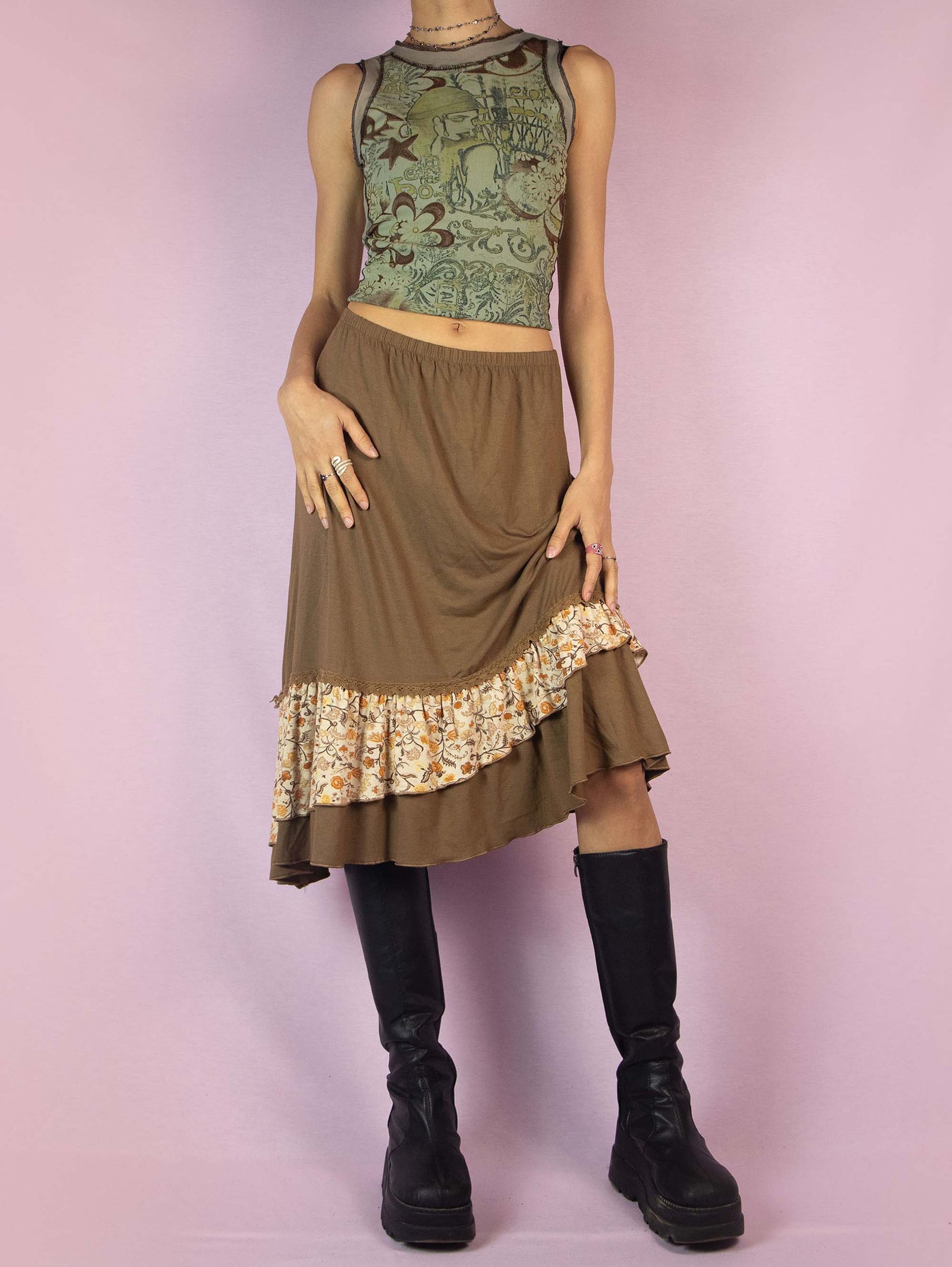 The Y2K Asymmetric Brown Midi Skirt is a vintage 2000s fairy grunge cottagecore style skirt with an asymmetric floral print ruffle hem and elastic waist.