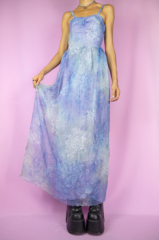 The Vintage 90s Floral Print Maxi Dress is a romantic gown featuring a delicate abstract pattern in shades of blue and lilac, a fitted bodice, a semi-sheer overlay, a flowing midi-length, and a side zipper closure, making it perfect for a dreamy summer party look.