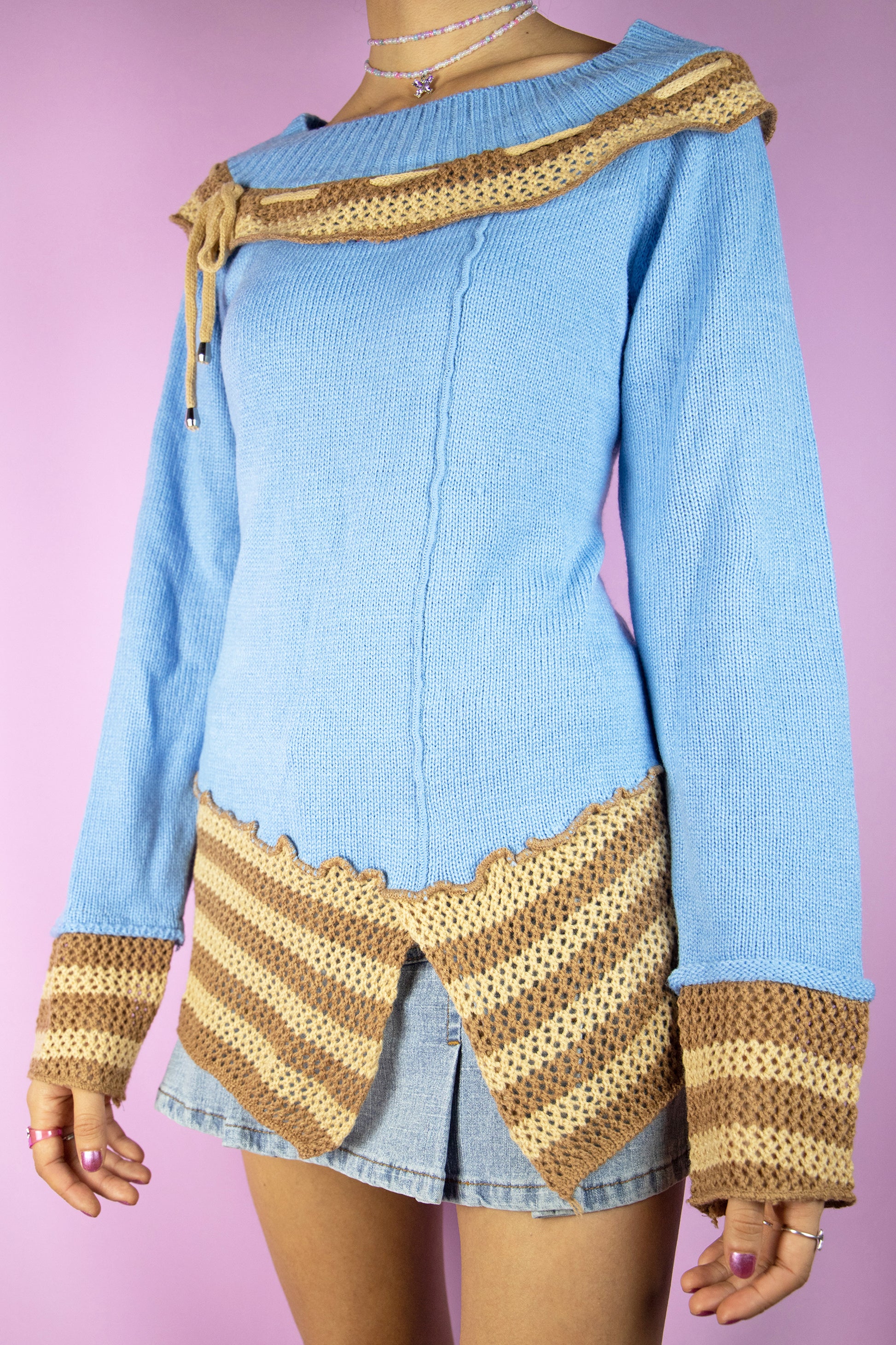 The Y2K Fairy Asymmetric Knit Sweater is a vintage 2000s boho grunge style blue pullover with brown and beige crochet details.