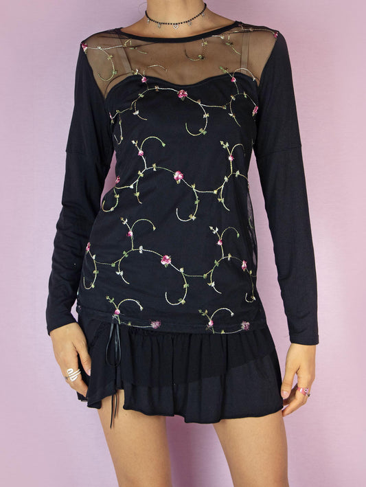 The Y2K Floral Mesh Black Top is a vintage 2000s long sleeve stretchy semi-sheer shirt with floral embroidery details.