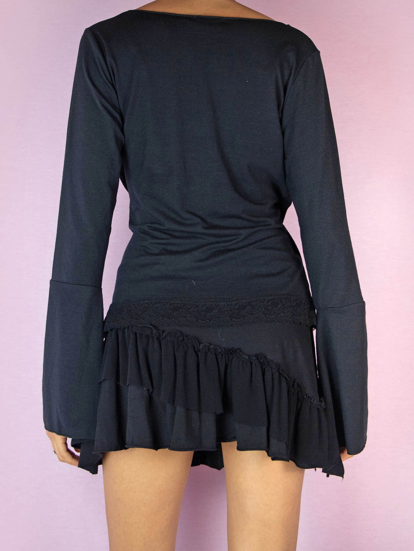 The Y2K Black Bell Sleeve Wrap Top is a stretchy long sleeve vintage 2000s fairy goth inspired shirt with a V-neck and lace details.