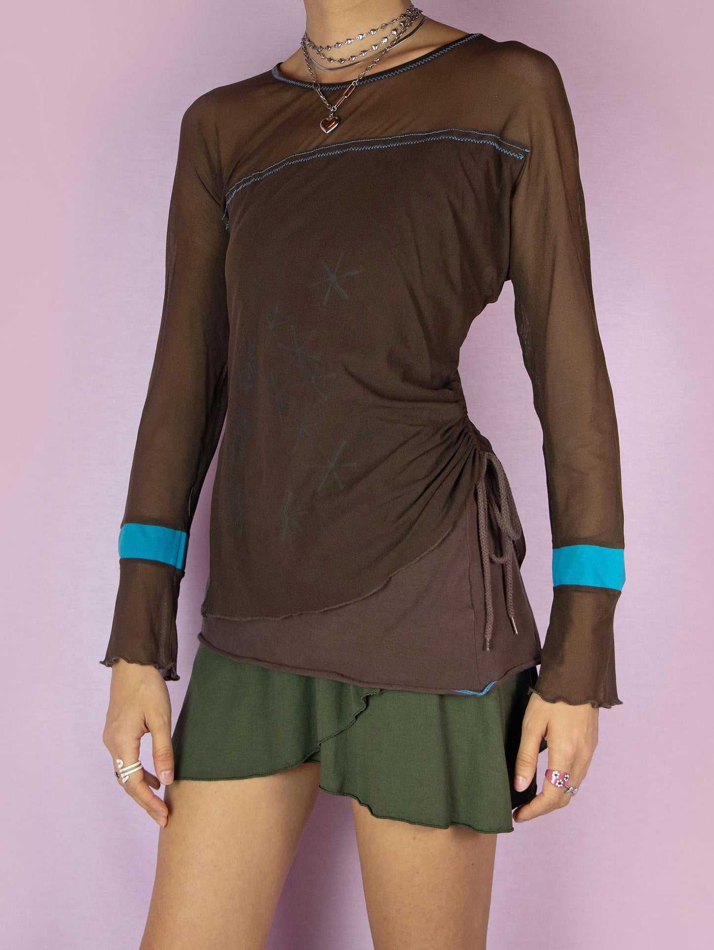 The Y2K Brown Mesh Asymmetric Top is a vintage 2000s subversive deconstructed long-sleeve semi-sheer layered shirt with a ruched side drawstring tie.