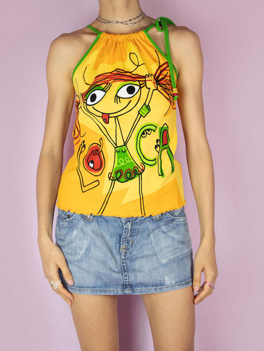 The Y2K Printed Sleeveless Top is a vintage 2000s yellow graphic halter top that features a vibrant cartoon design on the front, showcasing playful and colorful illustrations, making it perfect for a fun, casual summer look.