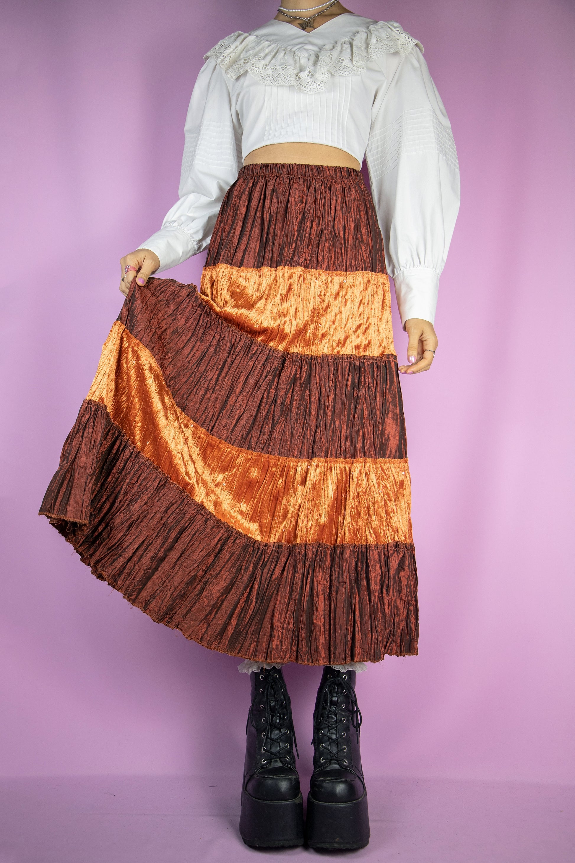 The Vintage 90s Boho Tiered Midi Skirt is a terracotta orange brown tiered pleated skirt with velvet and sequin details and an elasticated waist. Lovely milkmaid cottage prairie inspired 1990s peasant maxi skirt.