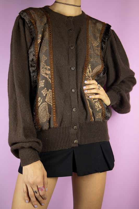 The Vintage 90s Brown Puff Sleeve Cardigan is a dark brown mohair blend knit sweater, featuring embroidered and faux fur details paired with puff sleeves. Perfect for a cozy, casual autumn or winter outfit.