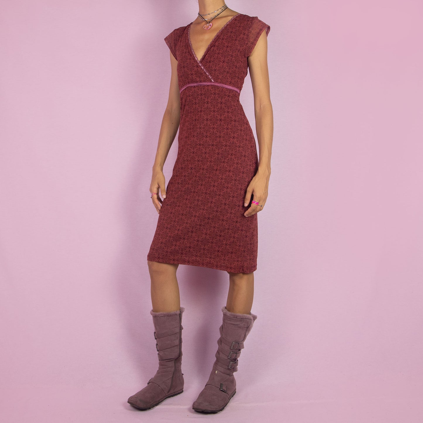 The Y2K Wrap Mesh Midi Dress is a vintage 2000s piece featuring a semi-sheer maroon-red mesh fabric with a geometric pattern. It has a flattering wrap-style V-neckline, cap sleeves, and a fitted silhouette. Perfect for casual summer outings.