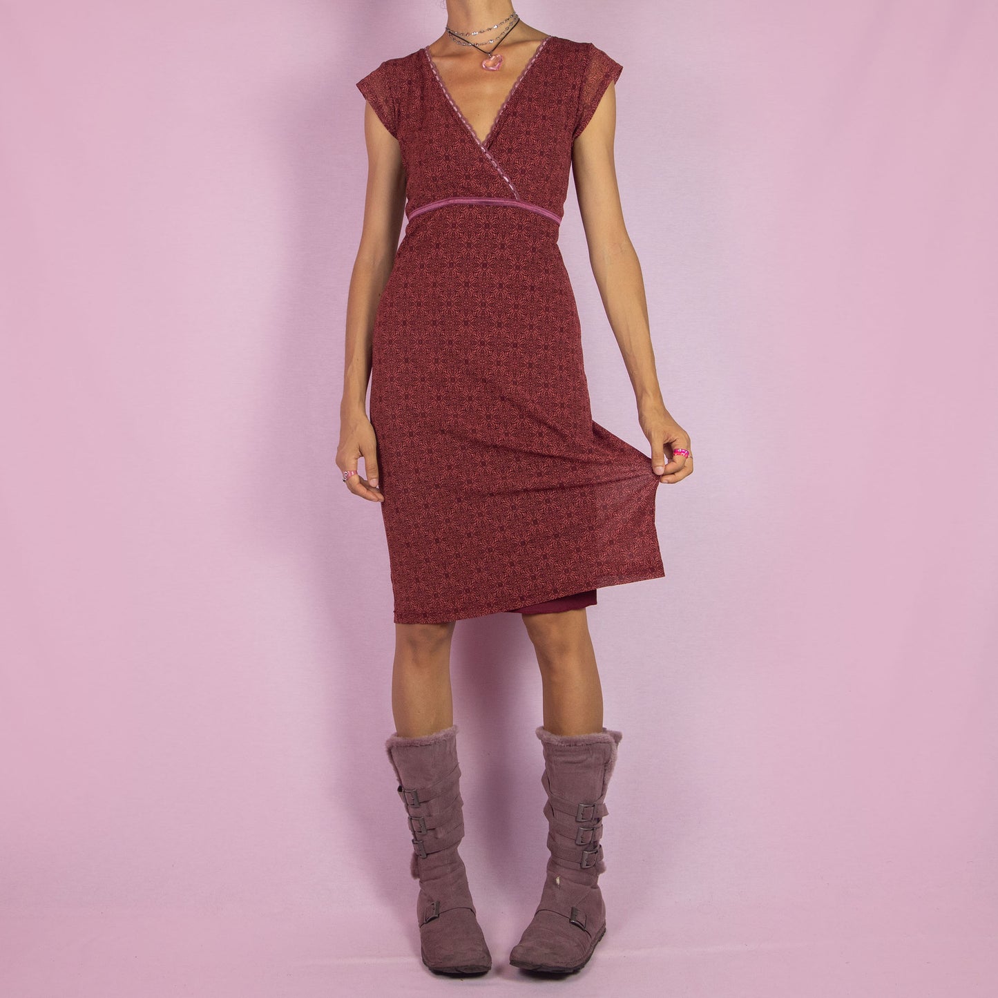 The Y2K Wrap Mesh Midi Dress is a vintage 2000s piece featuring a semi-sheer maroon-red mesh fabric with a geometric pattern. It has a flattering wrap-style V-neckline, cap sleeves, and a fitted silhouette. Perfect for casual summer outings.