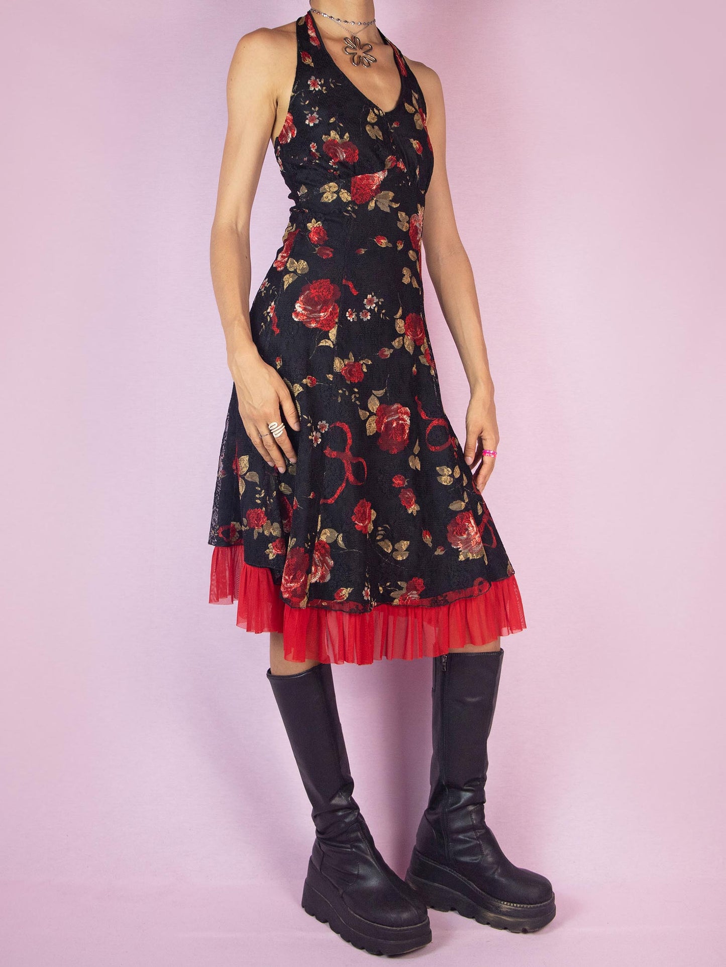 The Y2K Black Halter Lace Midi Dress is a vintage 2000s piece featuring a halter tie neck design, a red floral rose print mesh overlay, and a side zipper closure. Perfect for a summer party or a romantic evening out.