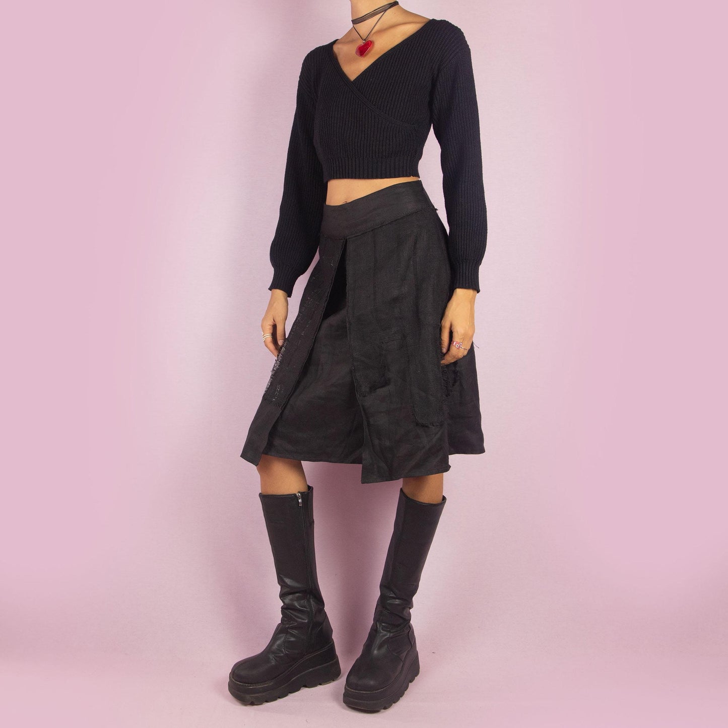 The Y2K Layered Black Midi Skirt features a unique design with contrasting text panels and raw hem details for an edgy and contemporary look. Its structured fit, midi length, low-rise waist, and back zipper closure make it perfect for casual looks.