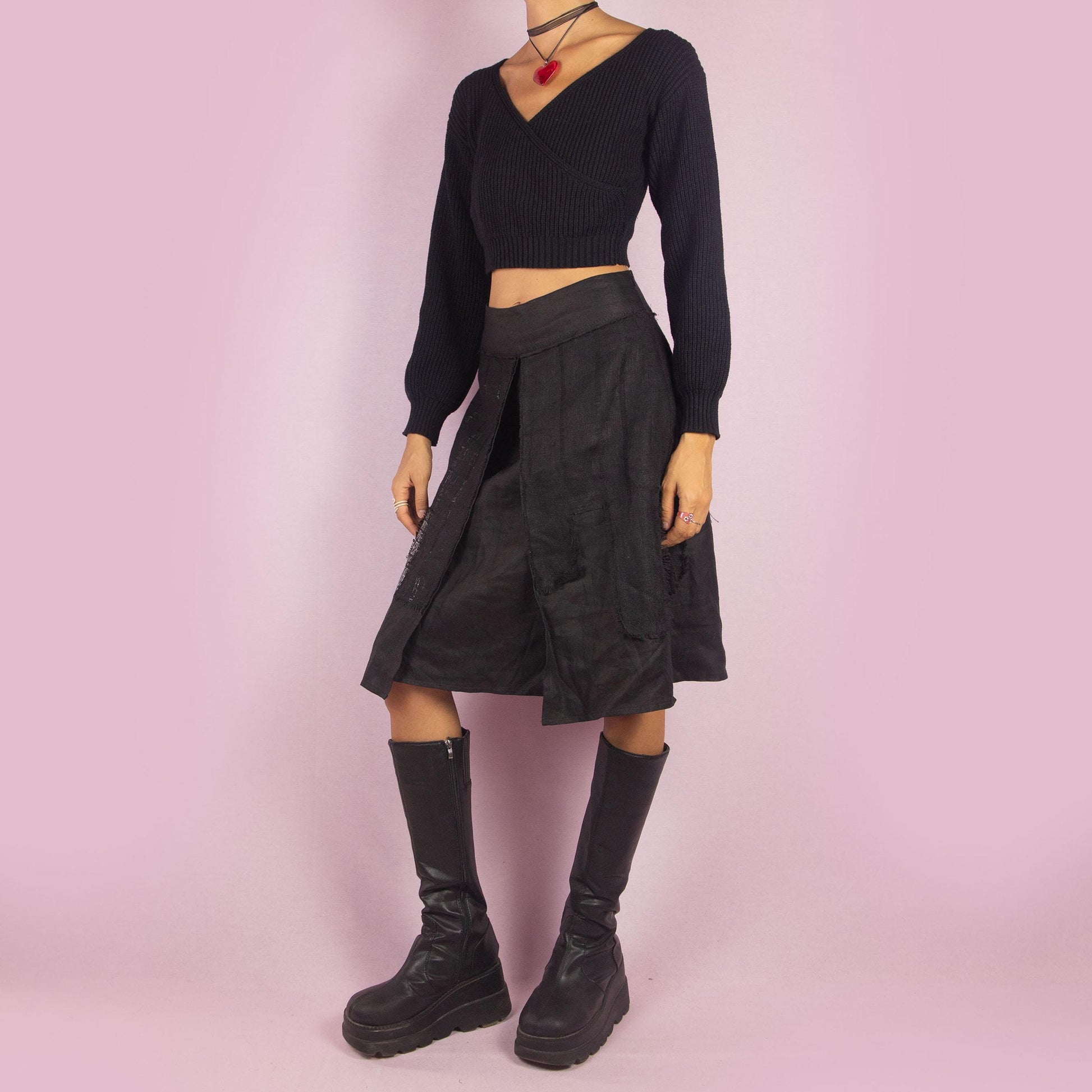 The Y2K Layered Black Midi Skirt features a unique design with contrasting text panels and raw hem details for an edgy and contemporary look. Its structured fit, midi length, low-rise waist, and back zipper closure make it perfect for casual looks.