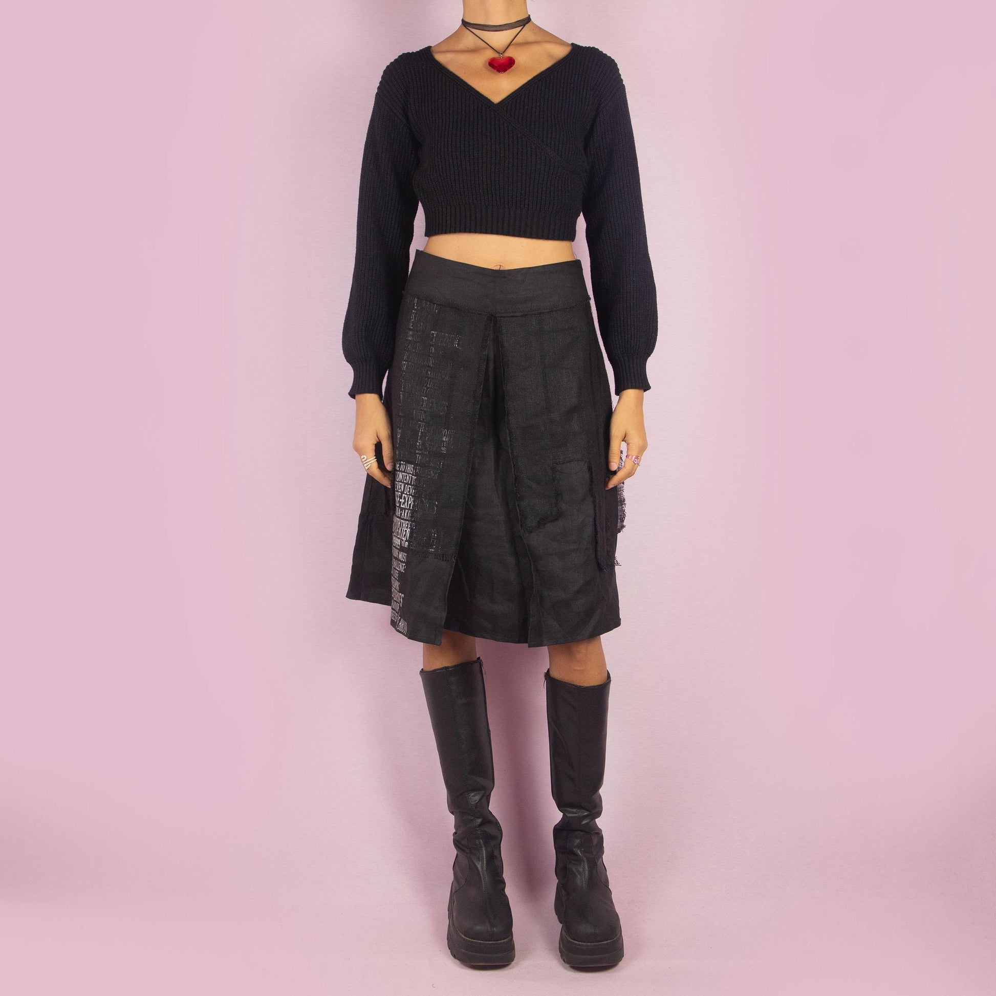 The Y2K Layered Black Midi Skirt features a unique design with contrasting text panels and raw hem details for an edgy and contemporary look. Its structured fit, midi length, low-rise waist, and back zipper closure make it perfect for casual looks.