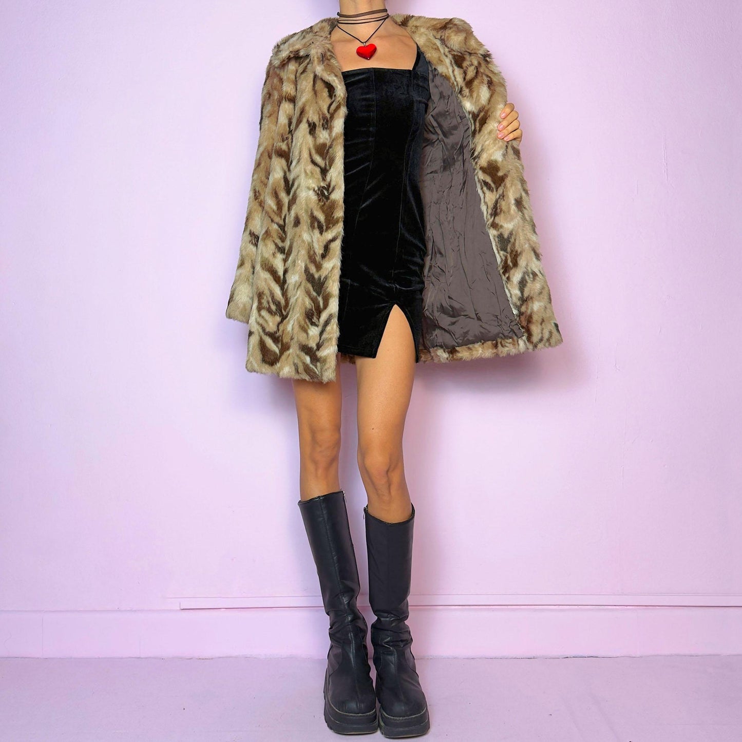 The Vintage 90s Chevron Faux Fur Coat is a cozy statement piece. Crafted with brown and beige soft faux fur, it features a pullover front closure and pockets. The bold pattern and relaxed fit make it ideal for stylish winter evening parties.