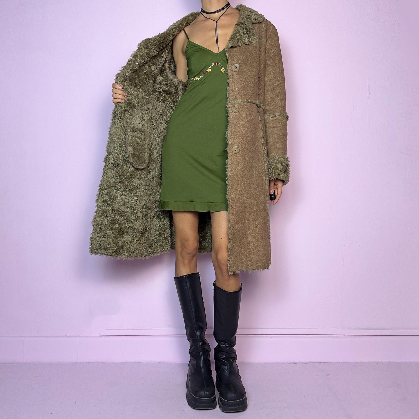 The Y2K Faux Fur Suede Long Coat is a vintage 2000s cozy piece featuring a soft brown faux suede exterior and faux shearling trim along the collar, cuffs, and seams. Its structured silhouette features button-front closure and pockets